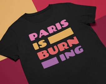 May include: Black t-shirt with the text "PARIS IS BURNING" in colourful block letters.