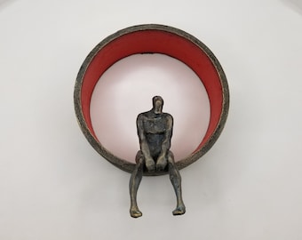 Small Beings sitting, red circle, wall sculpture, Yelitza Diaz, climber, art collection, men, original art, contemporary art, art collected