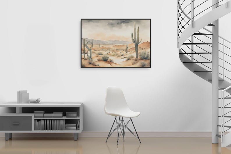 Minimalist charm fills the living space, where a white chair and silver bookshelf are paired with a striking beautiful watercolor desert landscape painting that completes the ambiance