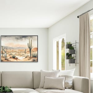 Sunlight pours through glass windows into a relaxed, energetic family room, where an artistic beautiful watercolor desert landscape painting steals the spotlight