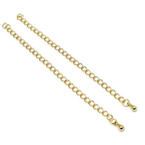 May include: Two gold chain extenders with a teardrop-shaped end piece.