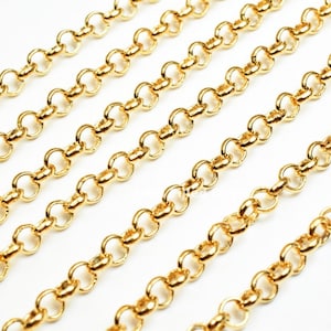 Puede incluir: Cadena de oro con eslabones redondos. La cadena está hecha de metal y tiene un acabado brillante.