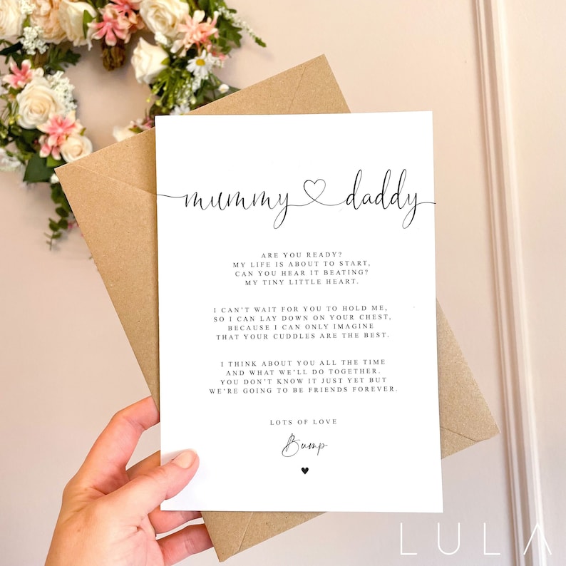May include: A white card with black text that reads "mummy daddy" with a heart symbol between the words. The text continues with a message from a baby to their parents about being excited to be born and how much they love their cuddles. The card is signed "Bump" with a heart symbol.