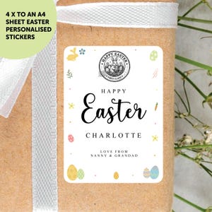 May include: Personalized Easter stickers with a white label featuring the text "Happy Easter" and the name "Charlotte". The label includes Easter egg and bunny illustrations. The stickers are on a brown package with a white ribbon.