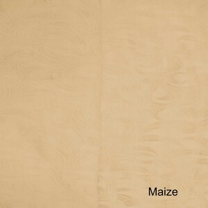 May include: A close-up of a textured, light beige fabric with the word "Maize" printed in black at the bottom.