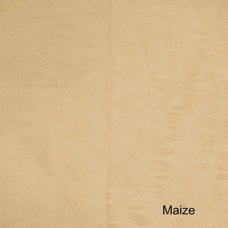 May include: A close-up of a textured, light beige fabric with the word "Maize" printed in black at the bottom.