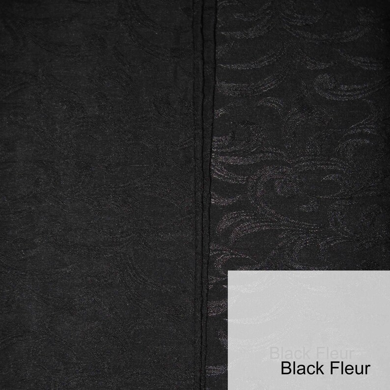 May include: Black fabric with a subtle embossed pattern. One side of the fabric is smooth, while the other side has a raised pattern. The fabric is labeled "Black Fleur".