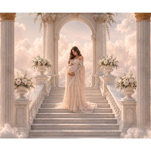 May include: A long, off-the-shoulder, cream-coloured maternity gown with long sleeves and a flowing skirt, worn by a person standing on a stone staircase between marble columns, surrounded by white floral arrangements and a cloudy sky background.