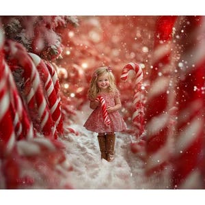 May include: A young girl in a red and white dress holds a candy cane in a snowy winter wonderland setting. The background is filled with red and white candy canes and snow.