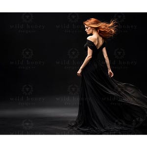 May include: A floor-length black gown with an off-the-shoulder neckline and a flowing, sheer skirt. The garment features a fitted bodice that transitions into a voluminous, layered skirt that trails behind, captured in a dynamic motion.
