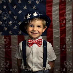 May include: A young boy wearing a white shirt, blue suspenders, and a red and white bow tie. He is smiling and wearing a blue and white hat with stars. The boy is standing in front of an American flag.