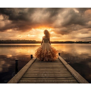 May include: A young girl in a long, flowing, peach-colored dress stands on a wooden dock overlooking a lake. The sky is a dramatic mix of dark clouds and a bright orange sunset.