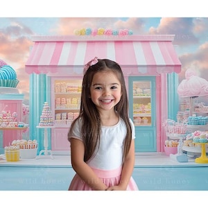 May include: A young girl with long brown hair is standing in front of a pink and white candy shop. The shop is decorated with colorful candies and sweets. The girl is wearing a white dress with a pink skirt and a pink bow in her hair.