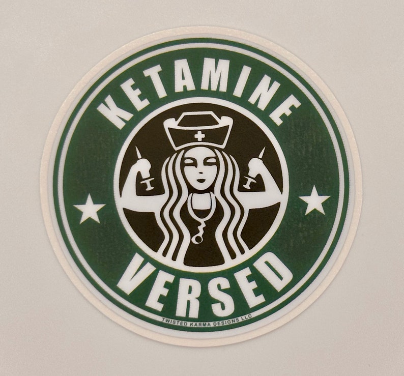 May include: A green and white round sticker with the text "KETAMINE VERSED" in a stylised font. A black and white illustration of a nurse with a syringe in each hand is in the centre of the sticker.