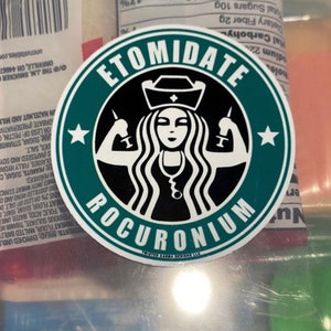 May include: A green and black round sticker with a stylised image of a woman wearing a nurse's hat and holding syringes. The text "Etomidate Rocuronium" is written in a circular pattern around the image.