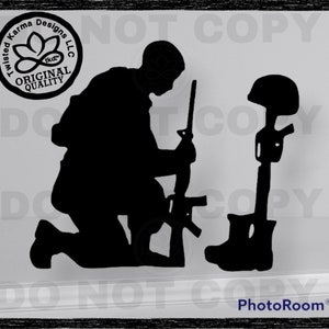 May include: Black silhouette of a soldier kneeling with a rifle, facing a helmet on a rifle, representing a fallen soldier.