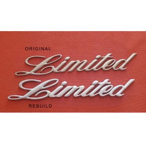 May include: Two "Limited" emblems, one in gold and one in silver, with the words "Original" and "Rebuild" printed below each emblem.