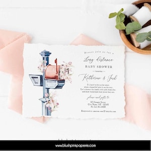 May include: A rectangular invitation card with deckled edges featuring a watercolor illustration of a blue mailbox overflowing with pink flowers. The text reads: Please join us for a Long Distance BABY SHOWER honoring Katherine & Josh.