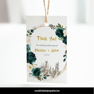 May include: A thank you tag with a gold and white floral wreath, a gray castle illustration, and the text "Thank You! for making today special Monique + Adam 12.12.22".