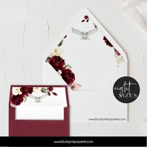 May include: A white envelope with a burgundy floral design and a white owl illustration. The envelope is folded in half and the back of the envelope has the text "www.blushpinkpaperie.com" and "eight sizes".