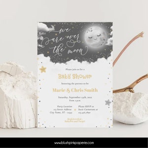 May include: A baby shower invitation with a gray and white background featuring a cartoon moon with a smiling face and stars. The text reads "We are over the moon" and includes details for the baby shower, including the date, time, location, and RSVP information. The invitation also includes the names of the parents-to-be, Marie & Chris Smith, and information about where they are registered.