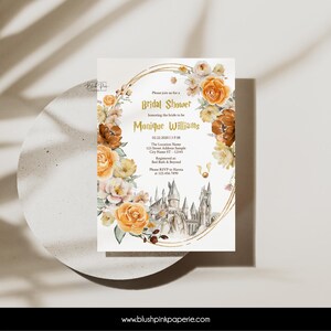 May include: A bridal shower invitation with a watercolor floral design in shades of orange, yellow, and pink. The invitation features a gold outline of a castle and the text "Please join us for a Bridal Shower honoring the bride to be Monique Williams 02.22.2020 13 P.M. The Location Name 123 Street Address Sample City Name ST-12343 Registered at: Bed Bath & Beyond Please RSVP to Hanna at 123.456.7890 www.blushpinkpaperie.com"