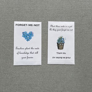 May include: Two white cards with blue forget-me-not flowers. The left card says "FORGET-ME-NOT" and "Teachers plant the seeds of knowledge that will grow forever". The right card says "Plant these seeds in a pot As they grow forget me not" and "Thank you for helping me grow!"