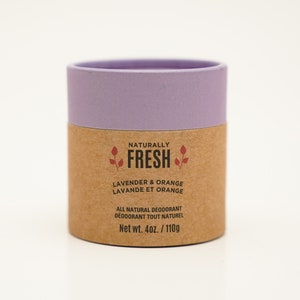 May include: A natural deodorant in a cardboard tube with a purple lid. The label reads "Naturally Fresh Lavender & Orange Lavande et Orange All Natural Deodorant Deodorant Tout Naturel Net wt. 4oz./110g"