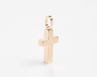 May include: A gold-colored cross pendant charm with a simple design. The cross is solid and has a smooth finish.
