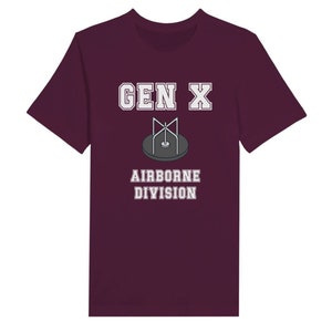 Bella Canvas 3001 T-Shirt with  the words generation X in white graphics a photo of a vintage play ground round and round and the words airborne division underneath in white graphics. The TShirt is maroon