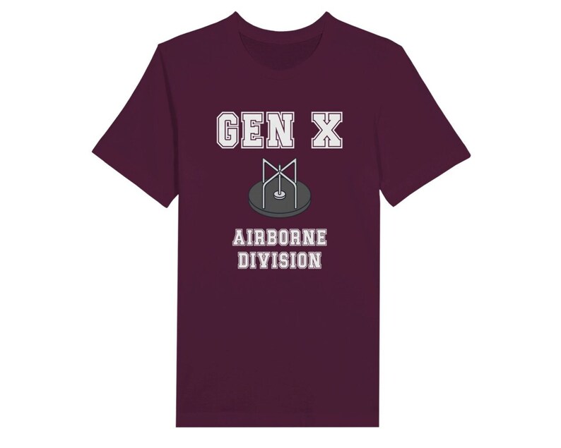 Bella Canvas 3001 T-Shirt with  the words generation X in white graphics a photo of a vintage play ground round and round and the words airborne division underneath in white graphics. The TShirt is maroon