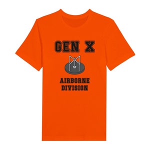 Bella Canvas 3001 T-Shirt with  the words generation X in black graphics a photo of a vintage play ground round and round and the words airborne division underneath in black graphics. The TShirt is orange