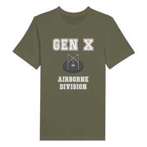 Bella Canvas 3001 T-Shirt with  the words generation X in white graphics a photo of a vintage play ground round and round and the words airborne division underneath in white graphics. The TShirt is military green