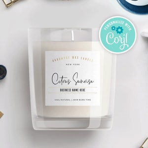 May include: A clear glass candle jar with a white label that reads "Handmade Wax Candle, New York, Citrus Sunrise, Business Name Here, 100% Natural, 48hr Burn Time". The label has a gold border and the text "Citrus Sunrise" is written in a cursive font. A sticker with the text "Personalize with Cory!" is on the right side of the image.