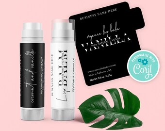 May include: Two white lip balm tubes with black labels. The label on the left tube says "coconut and vanilla" and "Nourishing Lip Balm". The label on the right tube says "Lip Balm" and "Nourishing Formula". Both labels have the text "Business Name Here". The label on the right tube also says "Coconut + Vanilla". A black label with white text says "organic lip balm" and "Vanilla" with the text "100% Natural & Vegan". The label also has the text "www.yourwebsitehere.com", "Made in California, USA", and "Net Wt. 0.15 oz / 4.25g". A blue circle with a white gear icon says "Personalize with Coril".