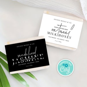 May include: Two bars of hand-crafted soap with black and white labels. The soap on the left is labelled "sandalwood jasmine" and the soap on the right is labelled "oatmeal milk/honey". Both soaps are 4 oz (120g). A blue sticker with the text "PERSONALIZE WITH Coryl" is in the bottom right corner.