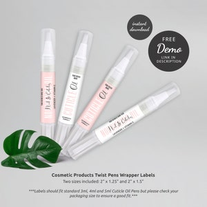 K&ouml;nnte beinhalten: Drei wei&szlig;e Twist-Stiftbeh&auml;lter mit rosa und wei&szlig;en Etiketten, auf denen "Nail & Cuticle Oil" und "Cuticle Oil" steht. Die Etiketten enthalten auch den Text "Lavender + Vitamin E" und "Nourishing Formula". Die Etiketten sind f&uuml;r Kosmetikprodukte konzipiert und in zwei Gr&ouml;&szlig;en erh&auml;ltlich: 5 cm x 3,175 cm und 5 cm x 3,81 cm.