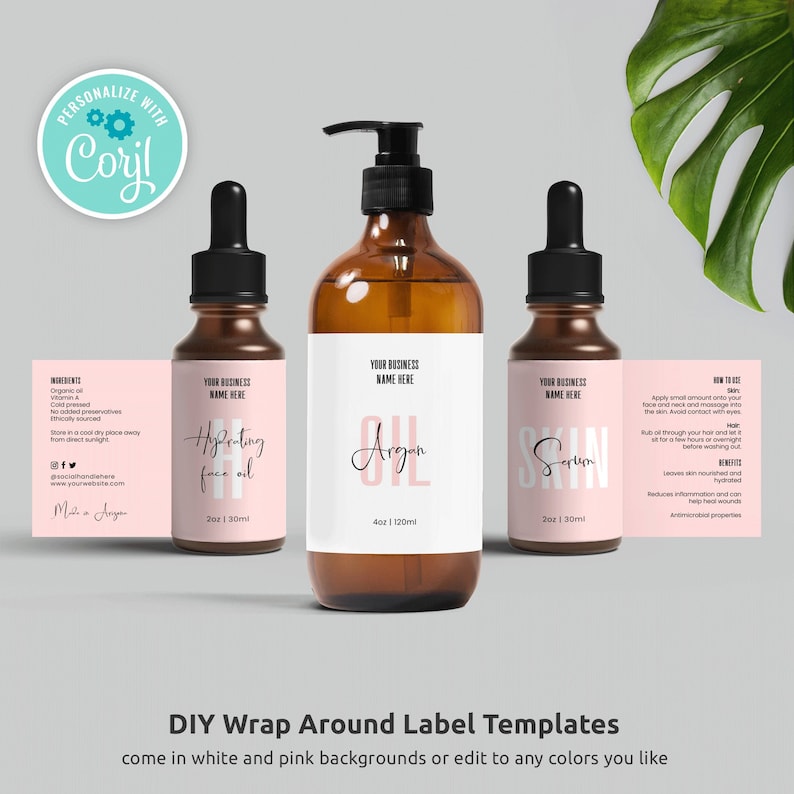 May include: Three amber glass bottles with white labels and pink text. The labels have the text "Your Business Name Here" and the names of the products: "Hydrating Face Oil", "Argan Oil", and "Skin Serum". The bottles are on a white background with a green leaf in the background.