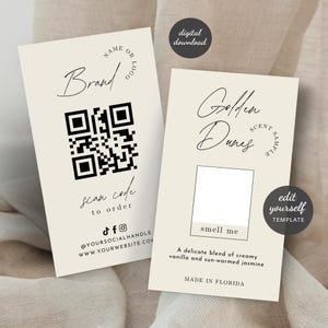 May include: Two cream-colored business cards with black text. One card has a QR code and the words "Brand", "scan code to order", and social media handles. The other card says "Golden Dunes Scent Sample" and "smell me".