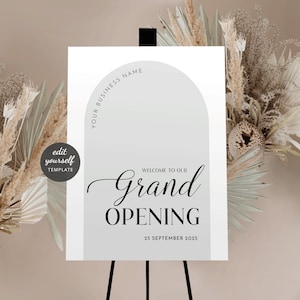 May include: A white sign with a grey arch shape at the top. The text "Your Business Name" is written in a circle around the arch. The text "Welcome to our Grand Opening" is written in a cursive font. The date "25 September 2025" is written below the text.