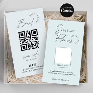 May include: Two light blue cards with black text and a QR code. One card says "Brand" and "scan code to order". The other says "Summer Flowers scent sample" and "smell me". The cards are in a white box.