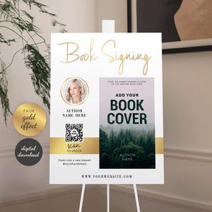 May include: A white sign on a stand with gold text that reads "Book Signing." The sign includes a photo of a woman, a QR code, and space for a book cover. Additional text includes "Add Your Book Cover" and "Author Name."