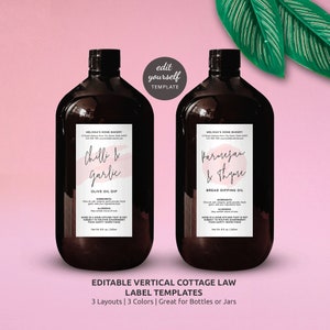May include: Two brown glass bottles with labels for Chilli & Garlic Olive Oil Dip and Parmesan & Thyme Bread Dipping Oil. The labels are white with pink watercolor accents and black text. The labels include the name of the bakery, Melissa's Home Bakery, and the ingredients and allergens. The bottles are on a pink background with green leaves.