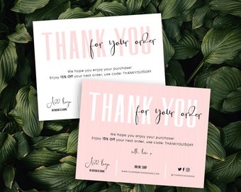 May include: Two pink and white thank you cards with black text. The text says "Thank you for your order" and "We hope you enjoy your purchase! Enjoy 15% off your next order, use code: THANKYOU15OFF". The cards also include a logo and contact information.