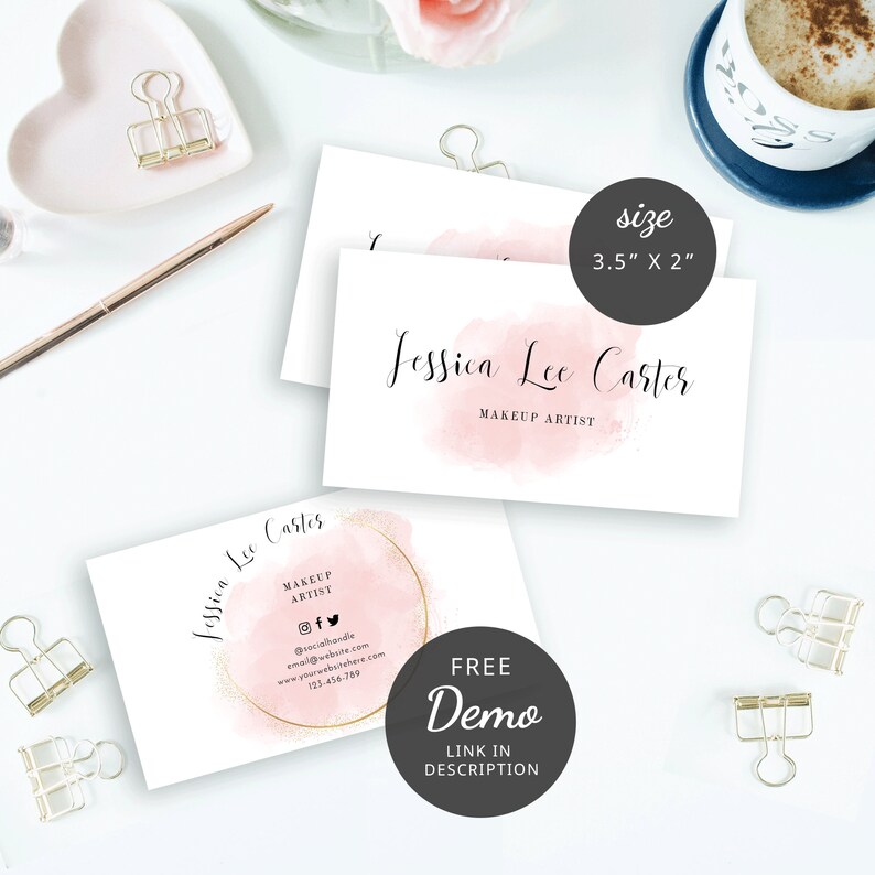 May include: Two pink and white business cards with a watercolor design and gold accents. The text on the card reads "Jessica Lee Carter, Makeup Artist". The card is 3.5 inches by 2 inches.