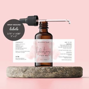 Puede incluir: Una botella de vidrio marrón con un gotero llena de aceite facial hidratante. La etiqueta es blanca con acentos de acuarela rosa y el texto "aceite facial hidratante" en escritura negra. La etiqueta también incluye los ingredientes, cómo usar y los beneficios del aceite.