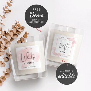 May include: Two candle jars with labels. The labels are white with a pink watercolor background. The text on the labels reads "White Jasmine" and "Soft Rose". Both labels say "Made in California | 8 oz".