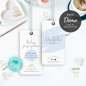 May include: Two white gift tags with blue watercolor accents. The top tag says "Fashion Boutique, California" and has social media icons. The bottom tag says "Thank you for your purchase" and has a discount code offer. Both tags have a hole for string.