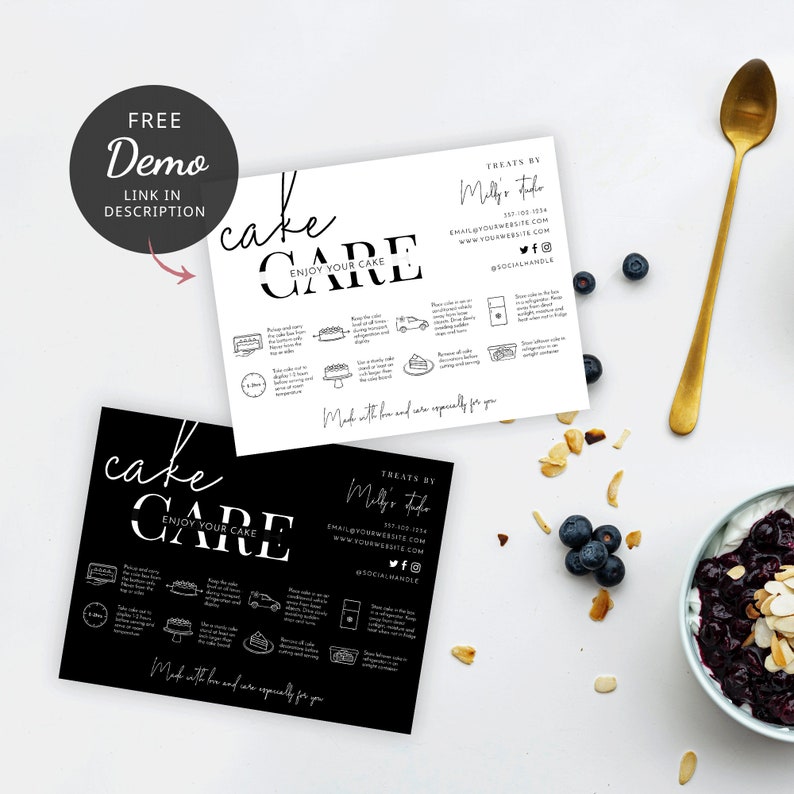 May include: Two black and white cards with the text "cake care" and instructions on how to enjoy your cake. The cards are on a white surface with blueberries, almonds, and a bowl of yogurt with blueberries.