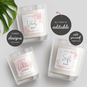 May include: Three candle jar labels with pink watercolor designs. The labels feature the text "Velvet Mist", "White Jasmine", and "Soft Rose" with the words "Made in California 8 oz" below each scent.